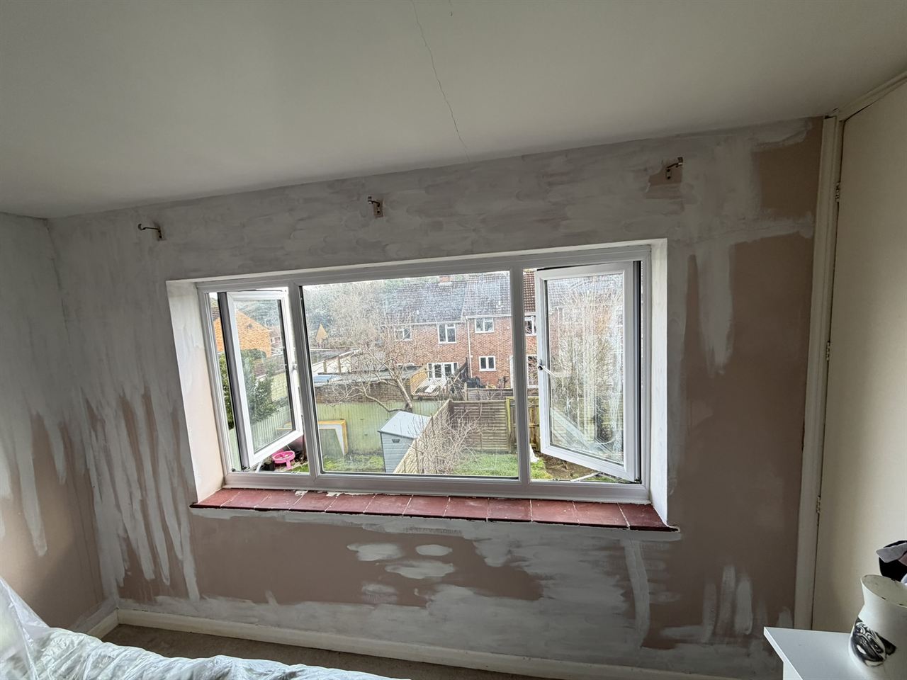 Bedroom window area after mould treatment, prepared for redecoration