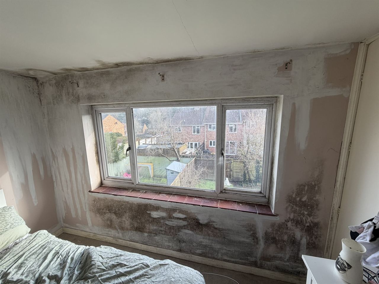 Mould around a bedroom window before treatment