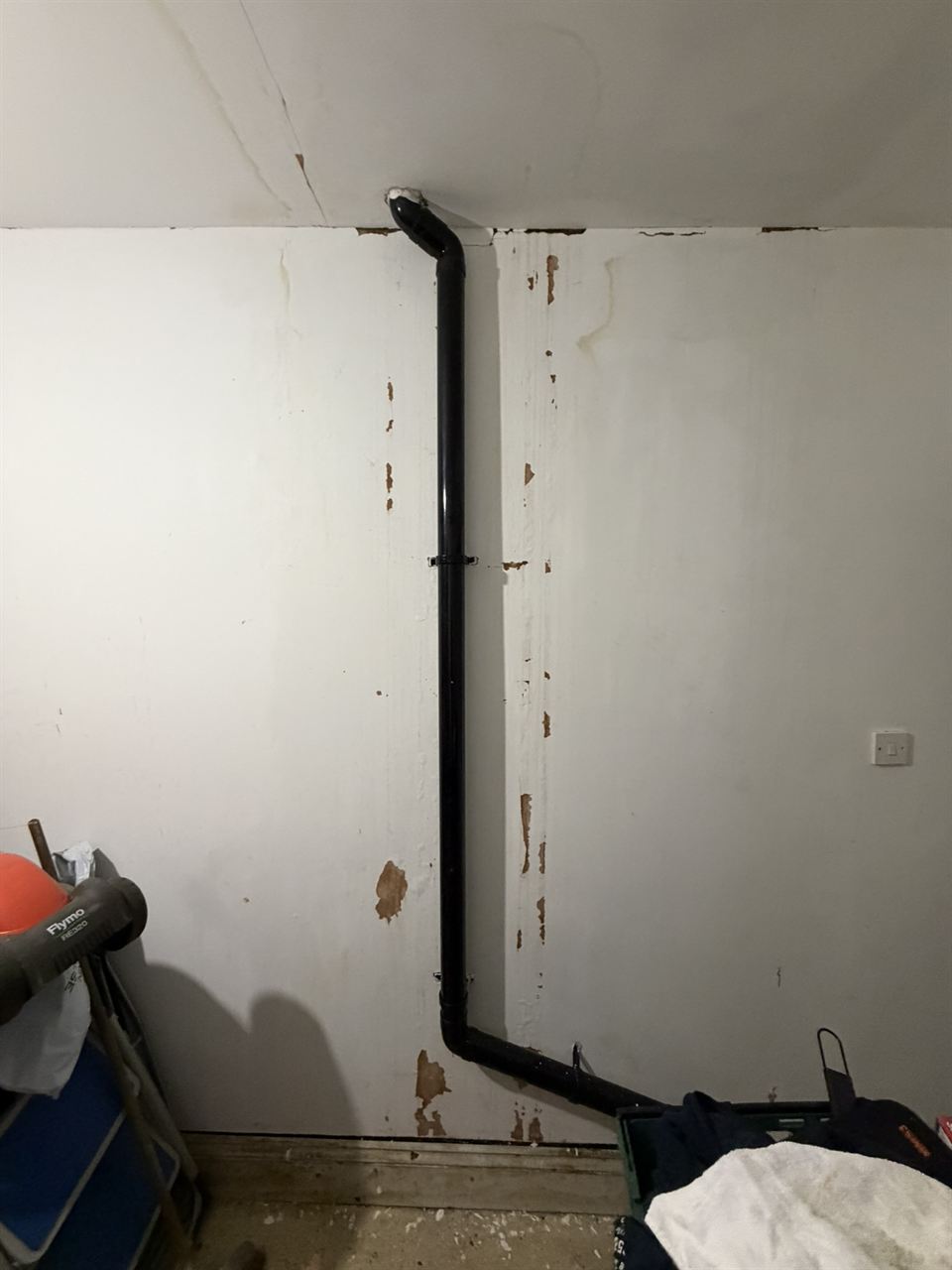 Wall beside a downpipe after mould treatment